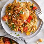 One Pot Greek Chicken and Orzo - Tender, juicy chicken and the creamiest orzo ever (that cooks right in the pan) topped with tomatoes + feta!