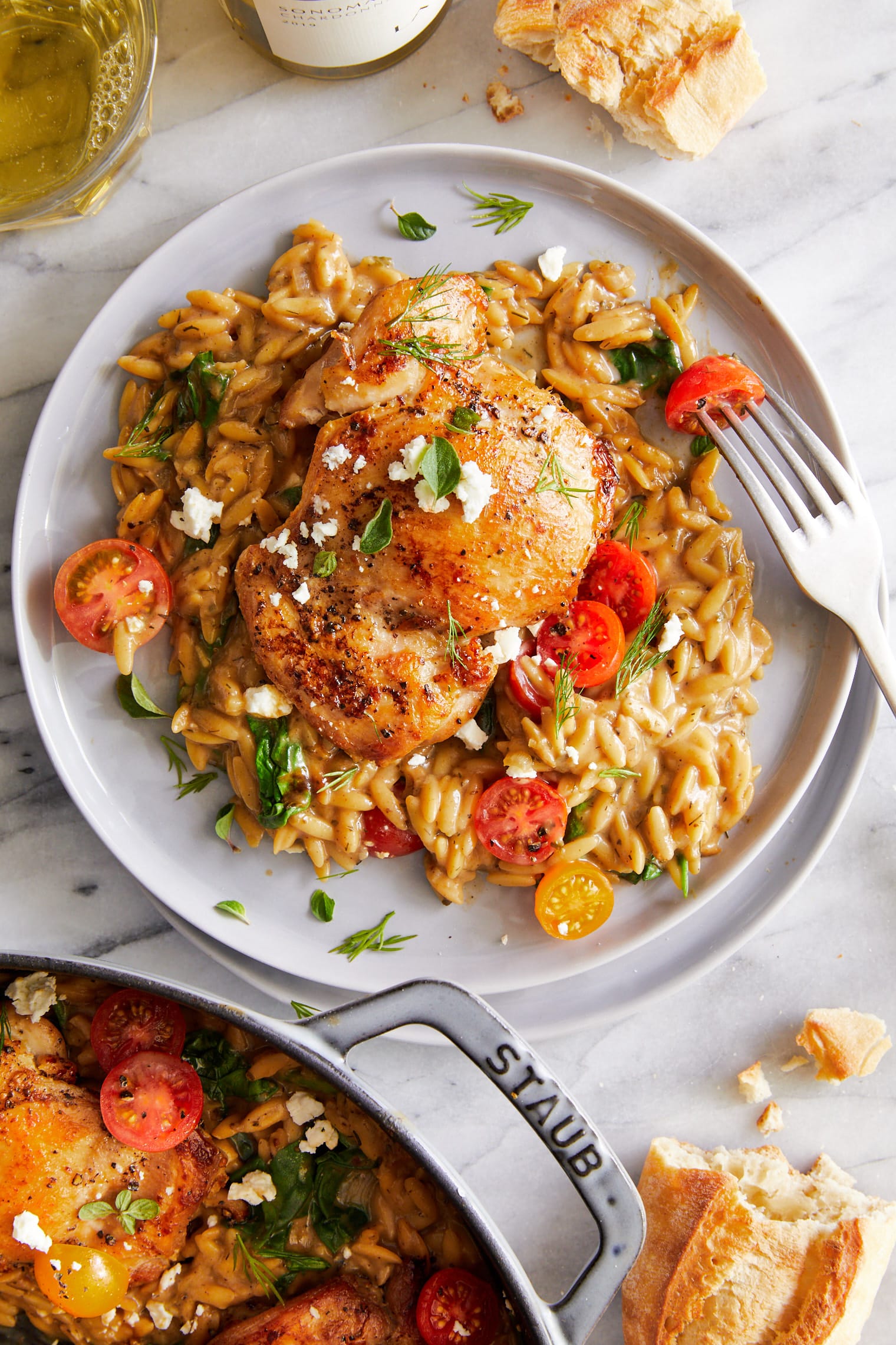 One Pot Greek Chicken and Orzo - Tender, juicy chicken and the creamiest orzo ever (that cooks right in the pan) topped with tomatoes + feta!