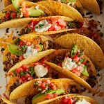 Baked Tacos - Crispy oven baked tacos! Made with hard taco shells, ground beef, taco seasoning, cheese, pico de gallo, sour cream + avocado!