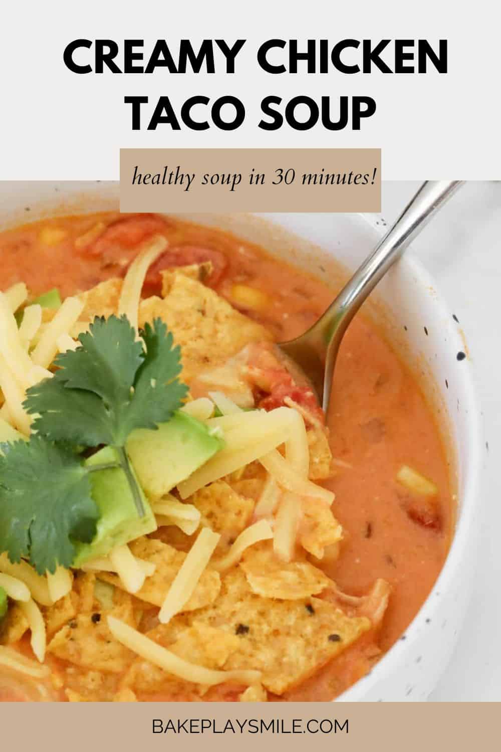 A bowl of creamy chicken taco soup with Mexican inspired toppings.