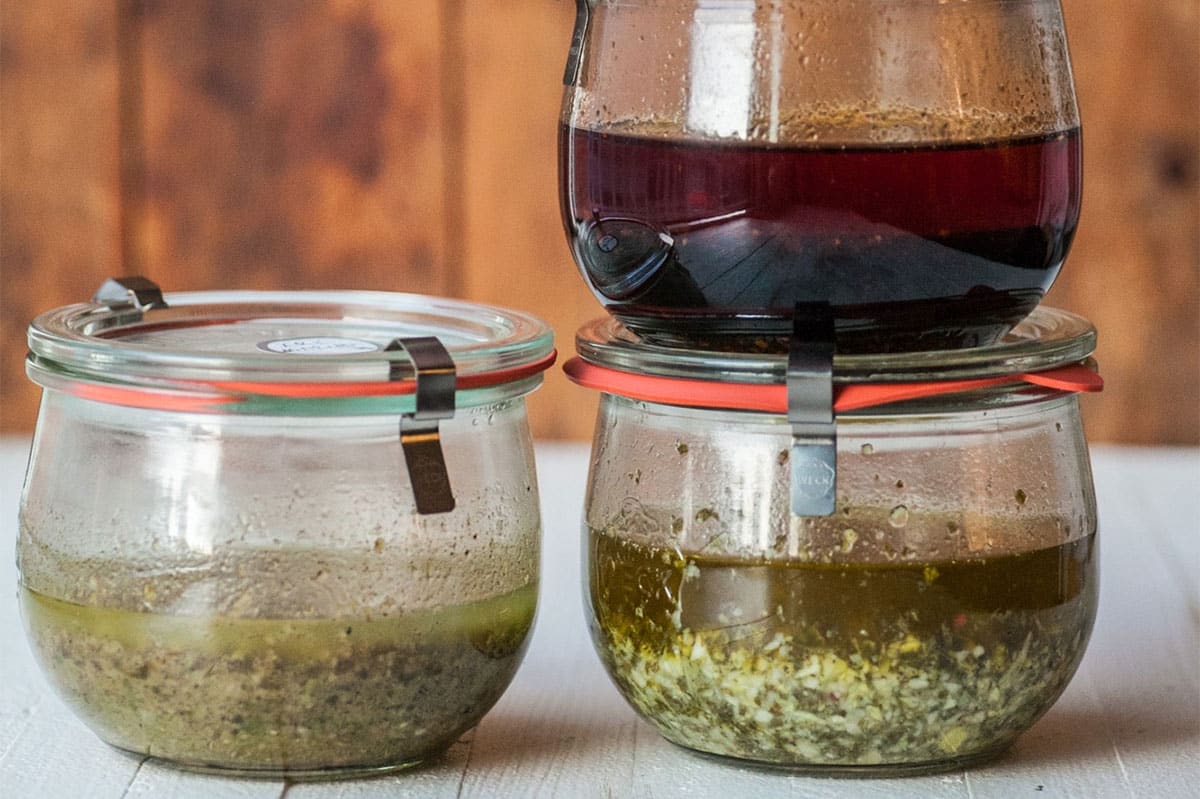 Various marinades in glass jars.