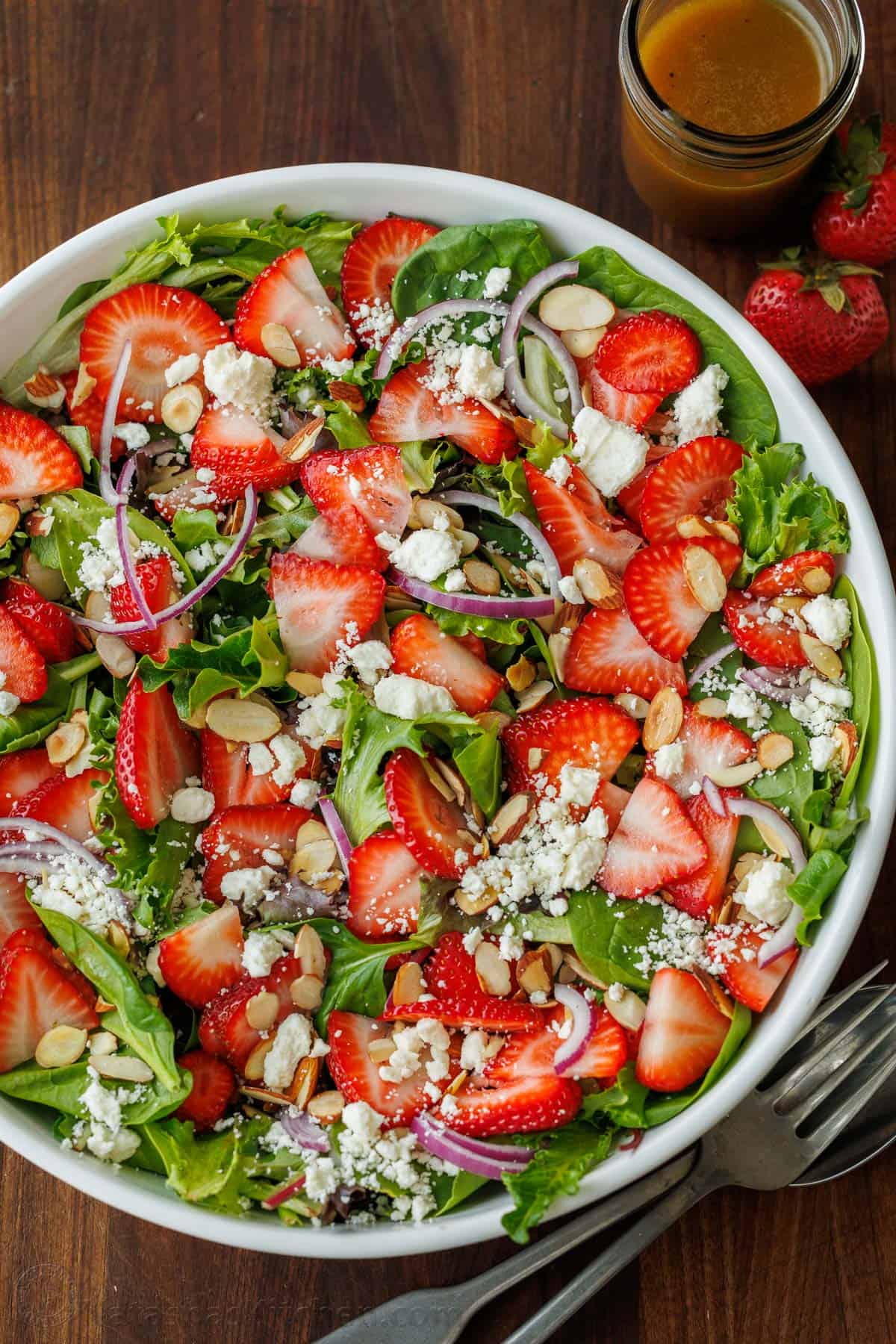 strawberry salad with honey vinaigrette in a white bowl