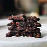 Gooey chocolate cookies stacked together.