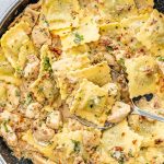 creamy sun dried tomato chicken ravioli in a skillet.