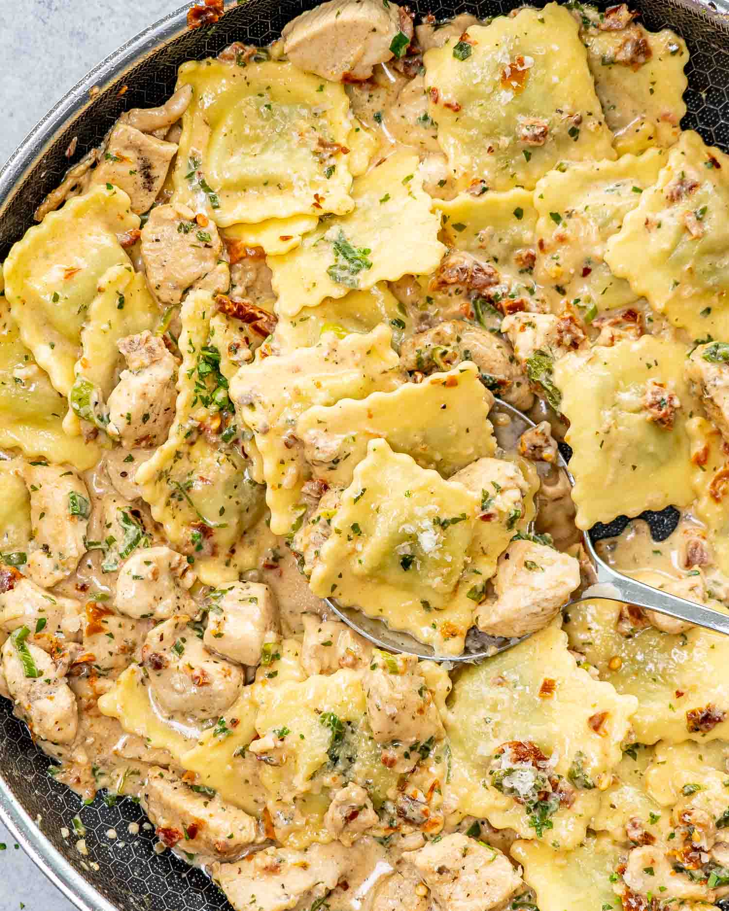 creamy sun dried tomato chicken ravioli in a skillet.