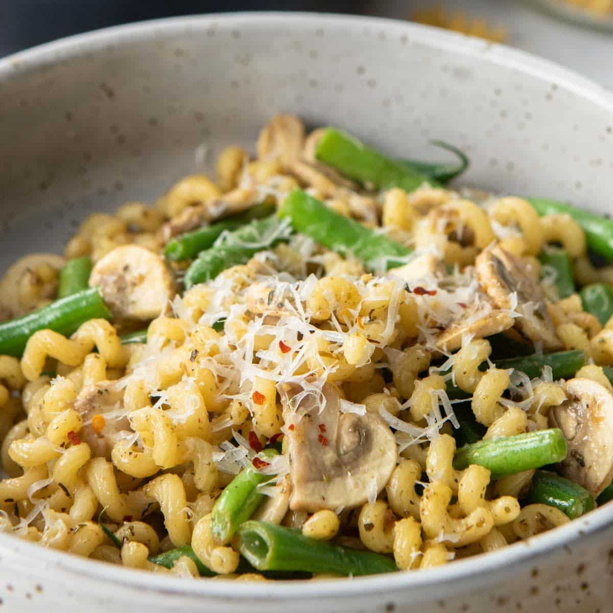 close up of mushroom, green bean pasta in bowl