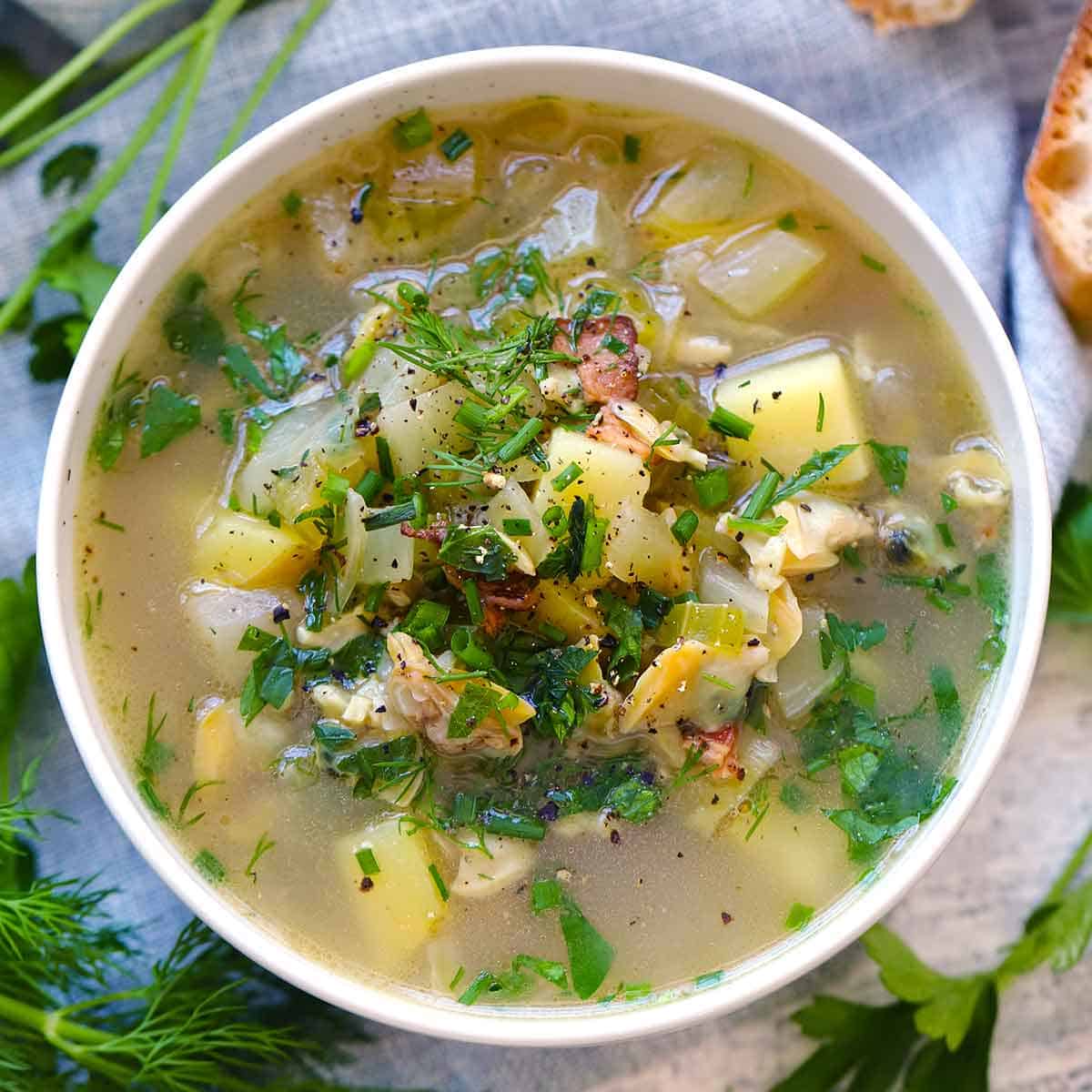 Square photo of Rhode Island Clam Chowder with clear broth, overhead photo.