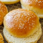 Cut homemade hamburger buns with sesame seeds