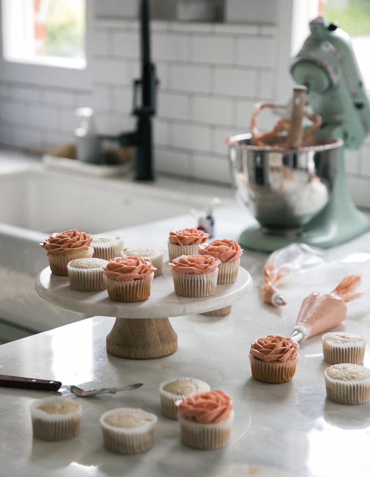 Frosted cupcakes on a cake plate.