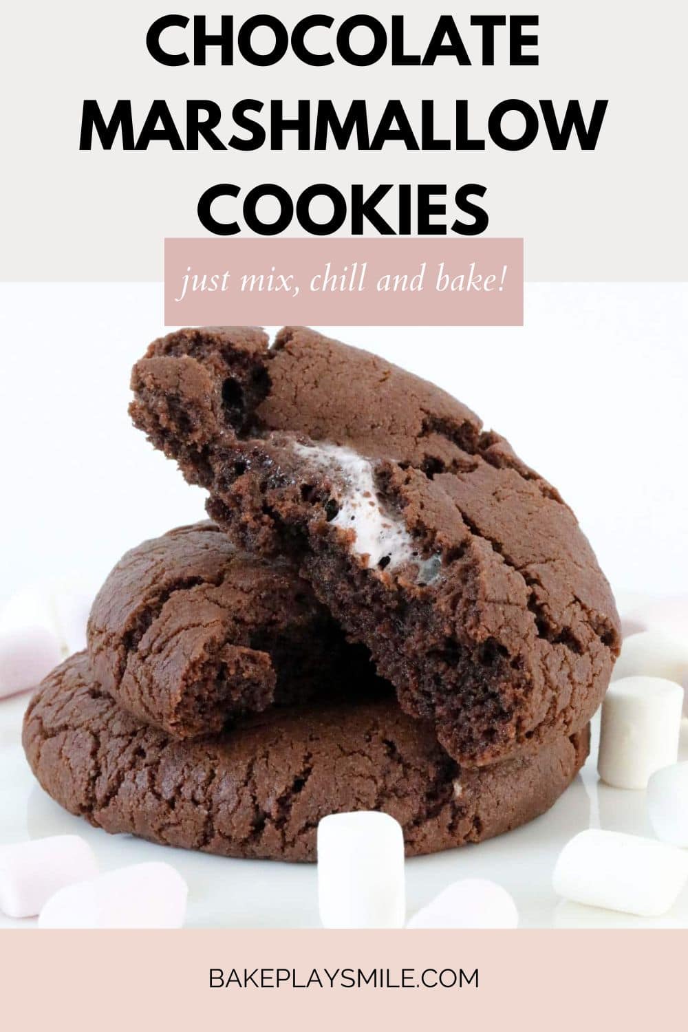 Three chocolate cookies with one showing marshmallow inside it.