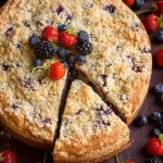 Triple Berry Cake Recipe sliced and garnished with berries