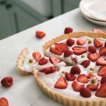 A sliced Gluten-Free Strawberry Tart on a counter.