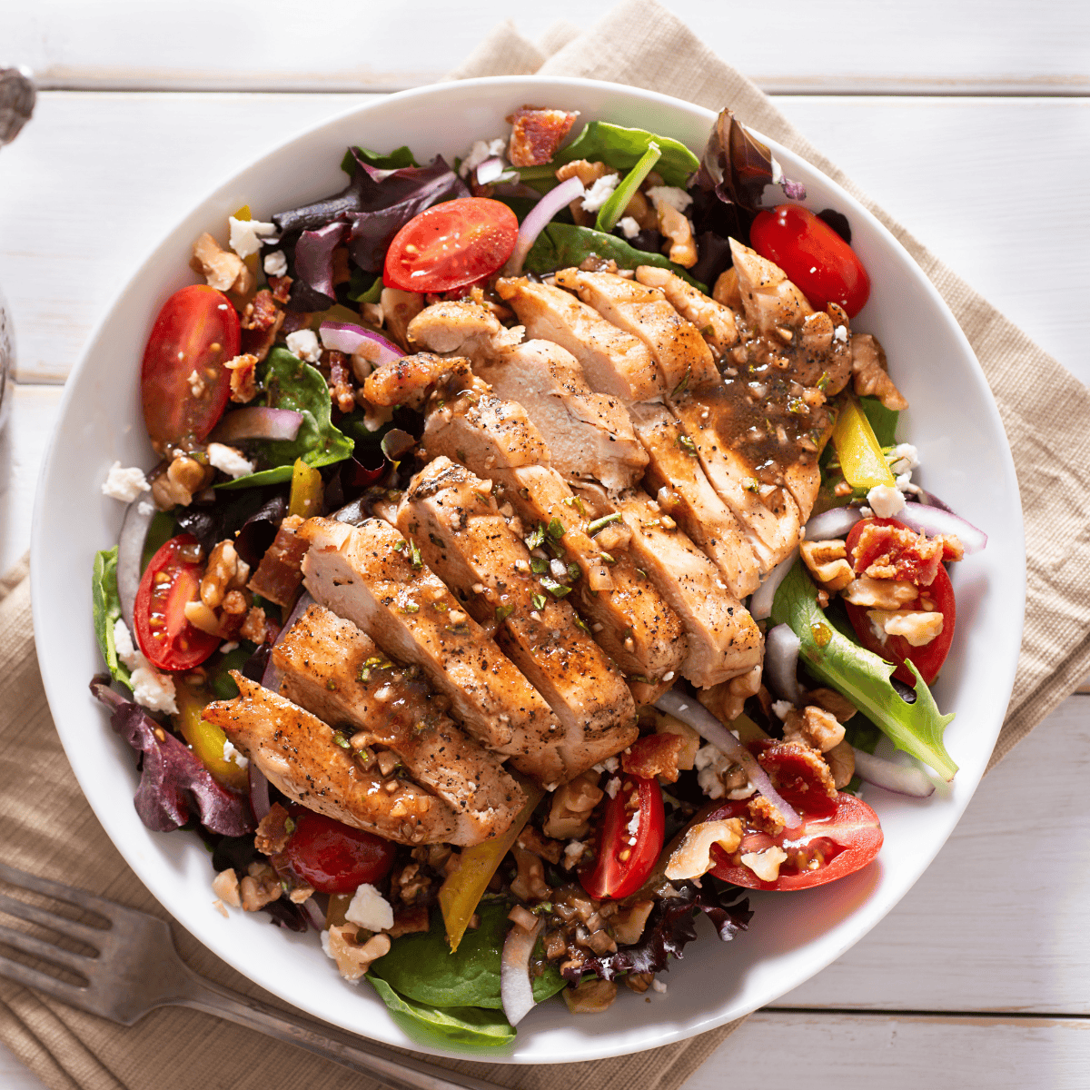 Overhead image of Honey Balsamic Chicken over a fresh salad