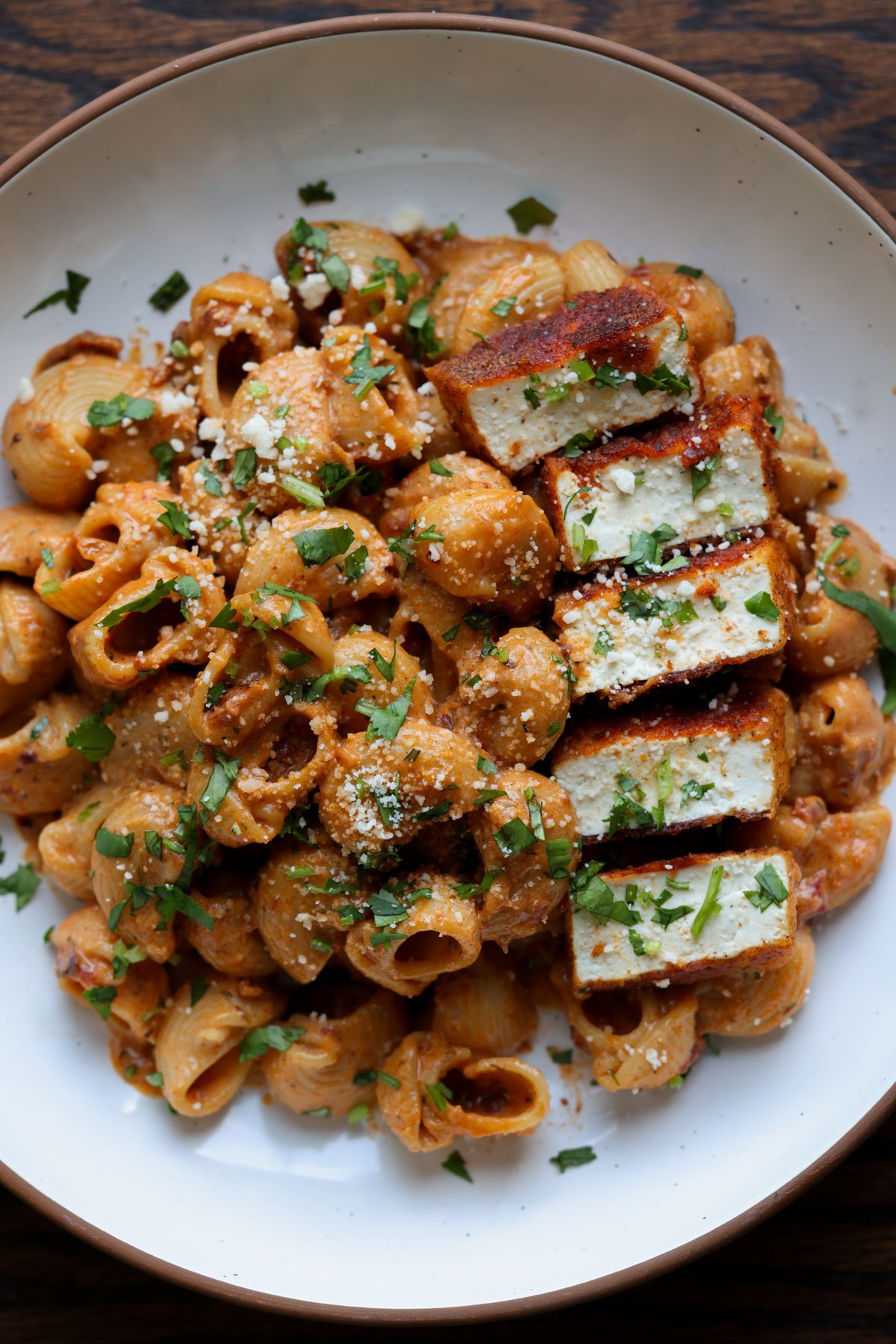 marry me pasta on a white plate with seared tofu pieces