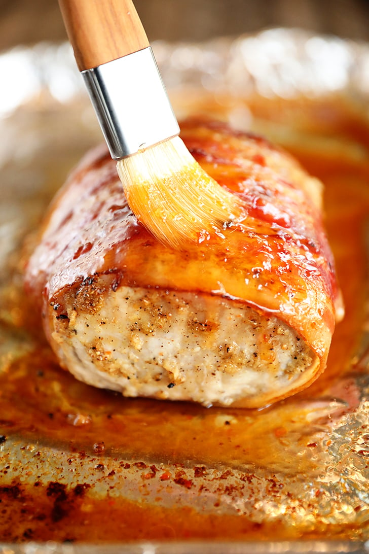 Brushing pepper jelly glaze on pork loin.