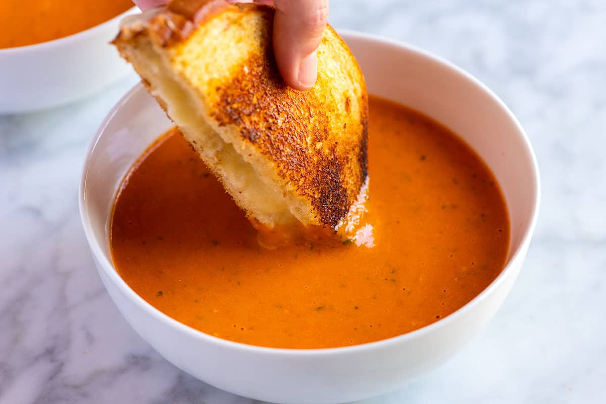 A bowl of Roasted Tomato Soup made with roasted tomatoes, basil, and garlic.