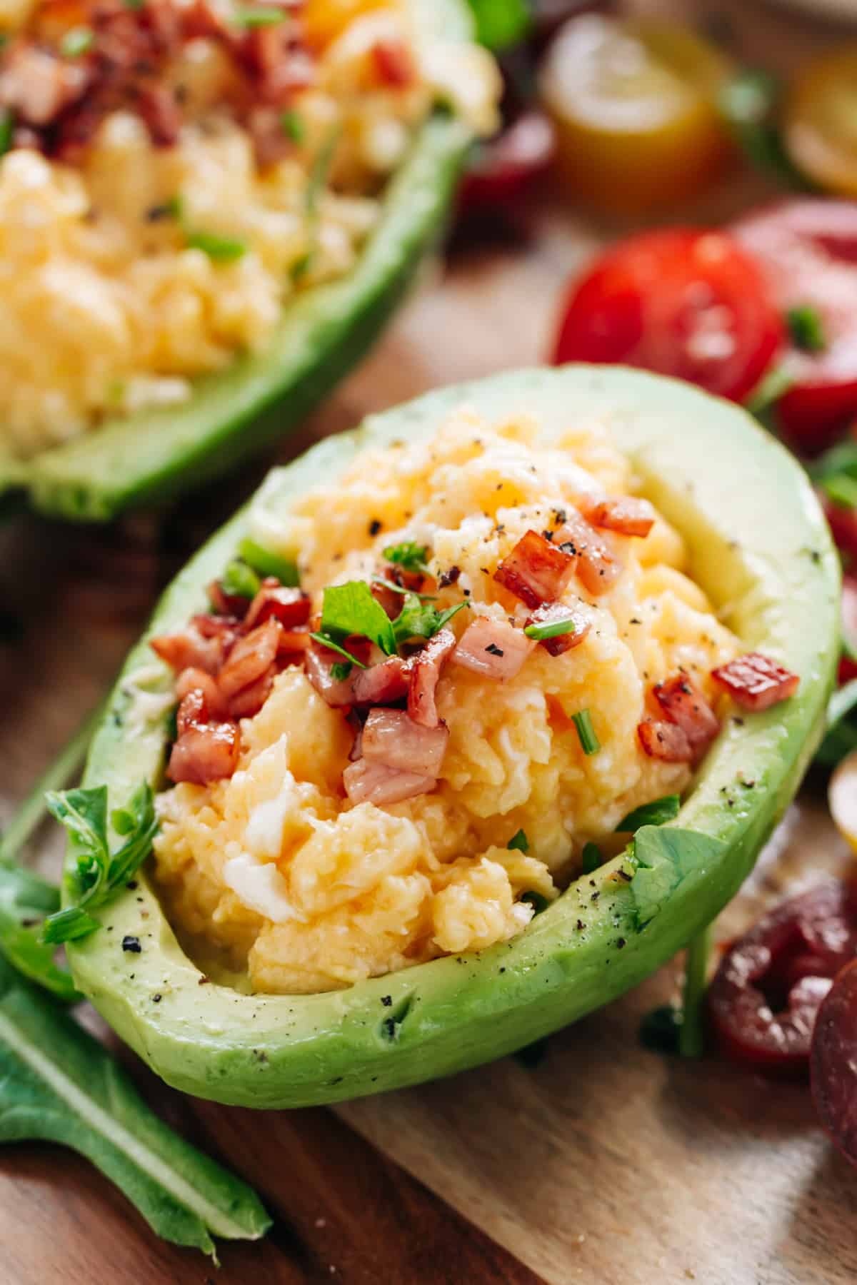 Soft scrambled eggs topped with crispy bacon and stuffed into halved, skinned avocados.