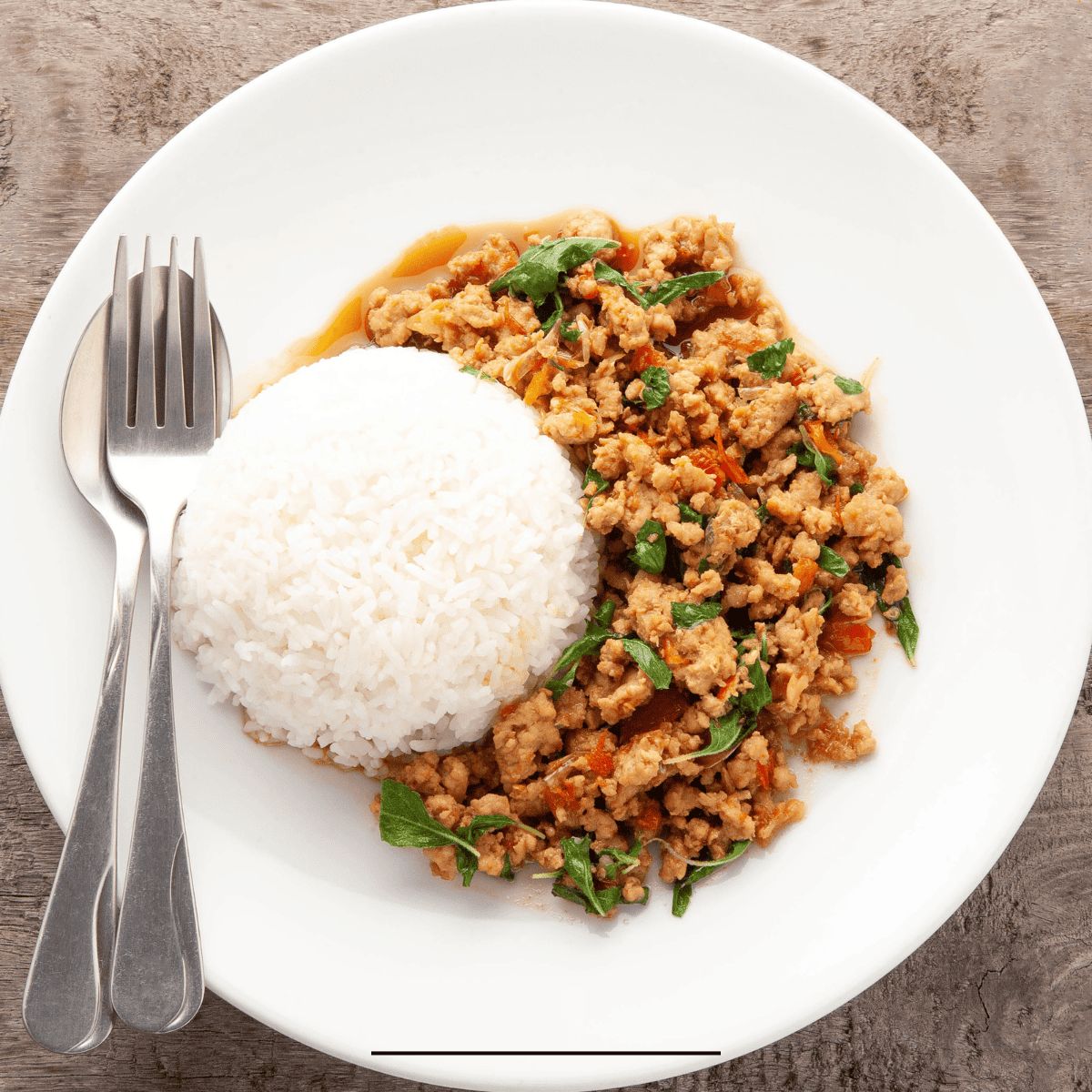 Overhead image of Thai Basil Chicken on a white plate with rice