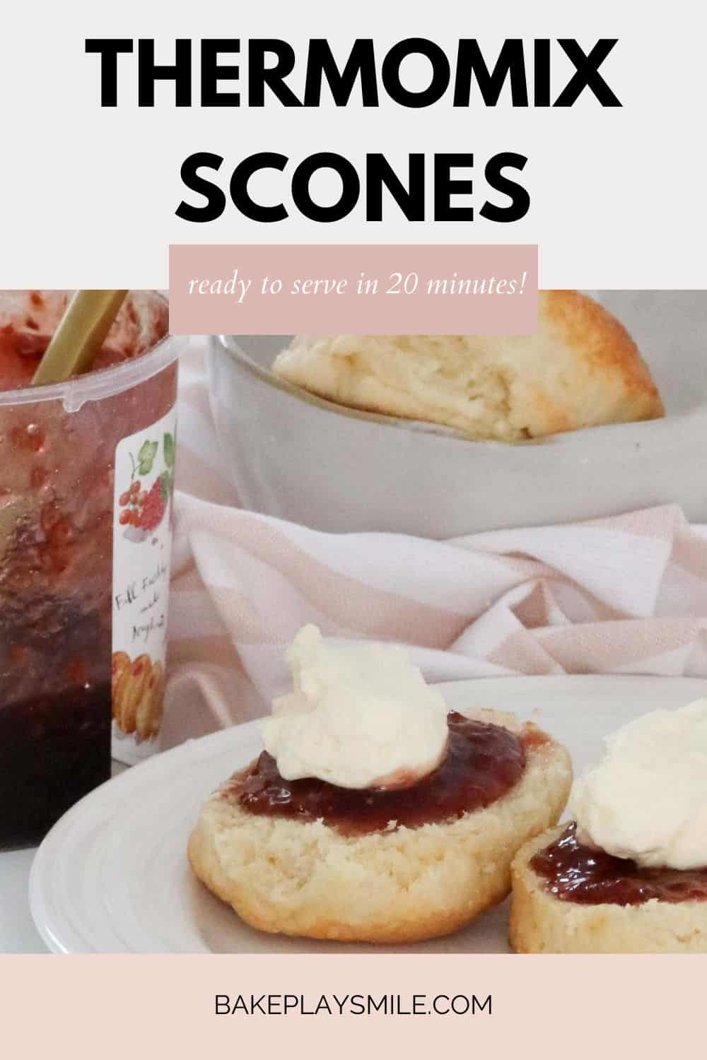 Fresh scones cut and served with jam and whipped cream.