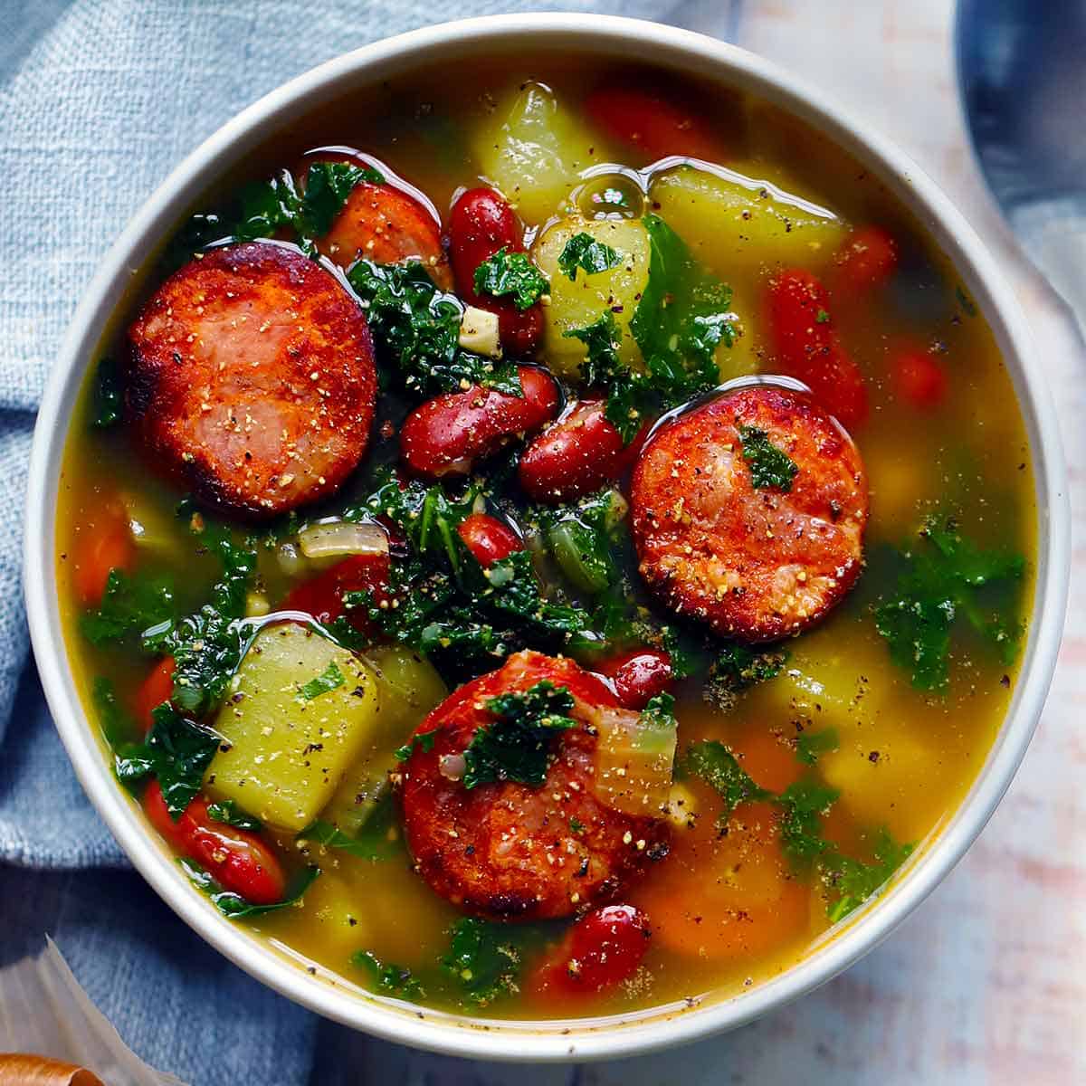 Square overhead photo of caldo verde, or Portuguese green soup with kale.