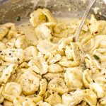 freshly made creamy tortellini in a skillet.