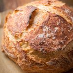 a loaf of No-Knead Artisan Bread on wood cutting board