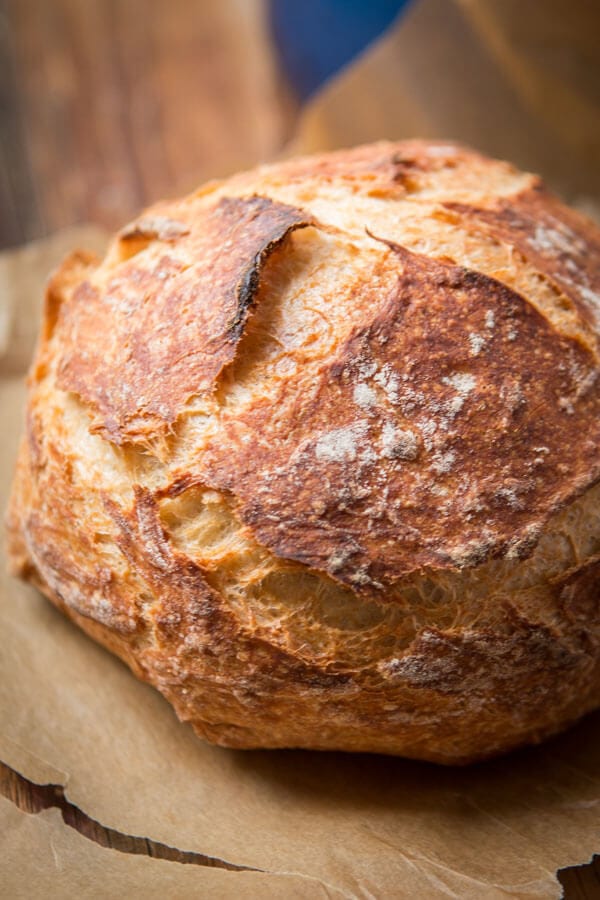 a loaf of No-Knead Artisan Bread on wood cutting board