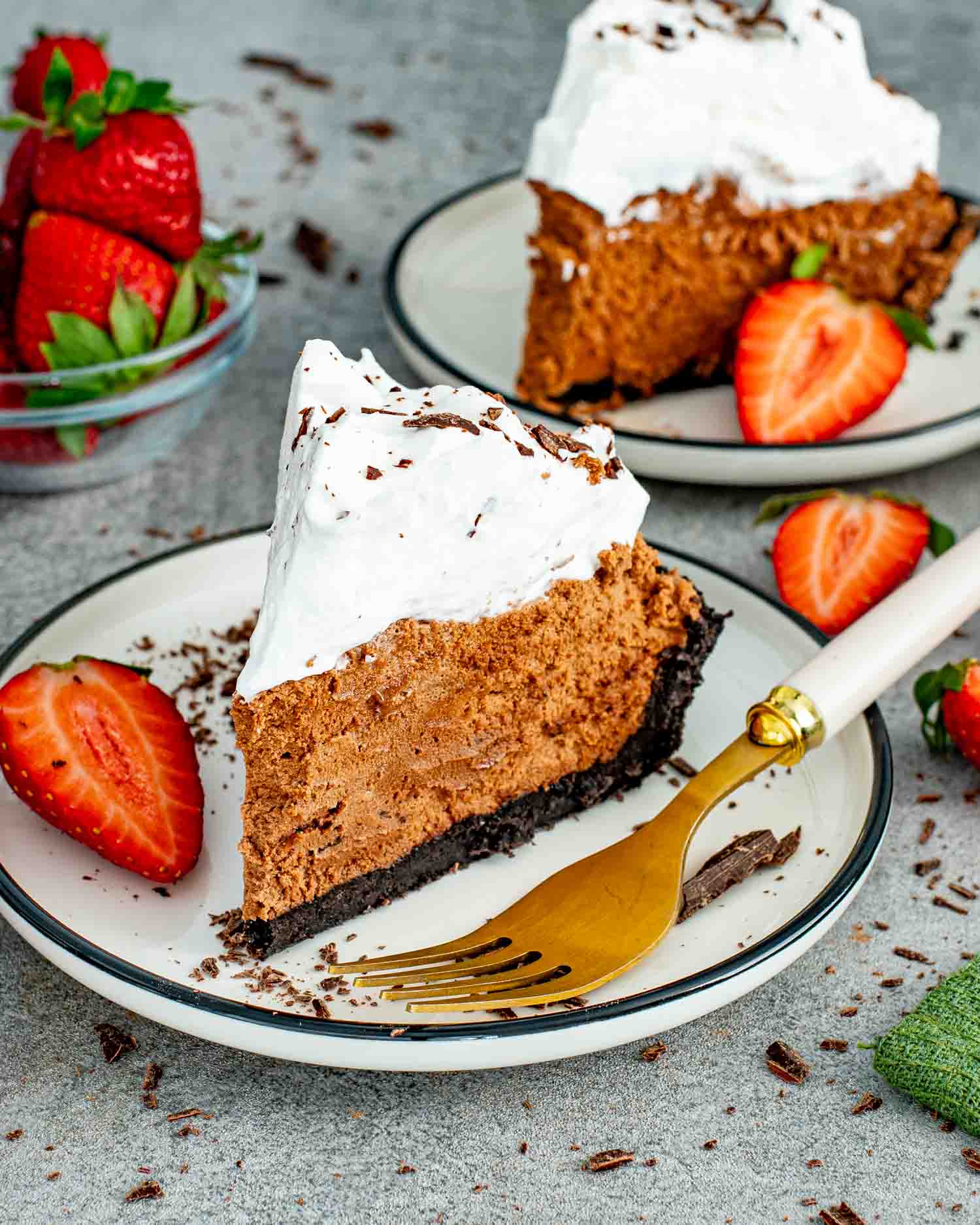 a slice of French silk pie on a dessert plate garnished with chocolate shavings.