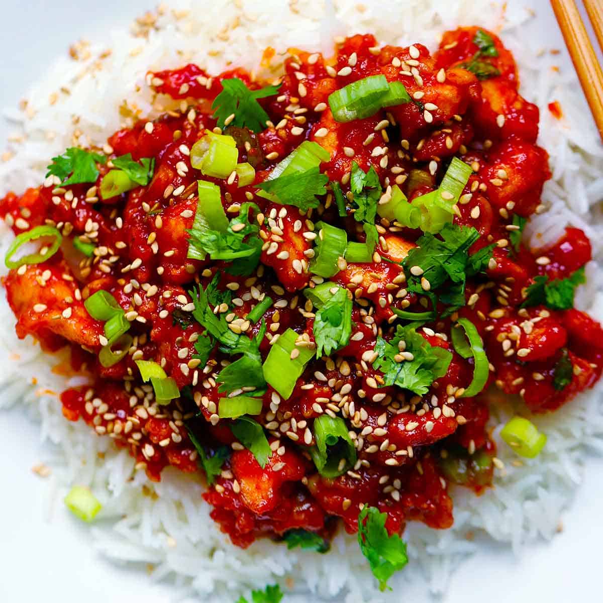 Square photo of gochujang tofu over rice.