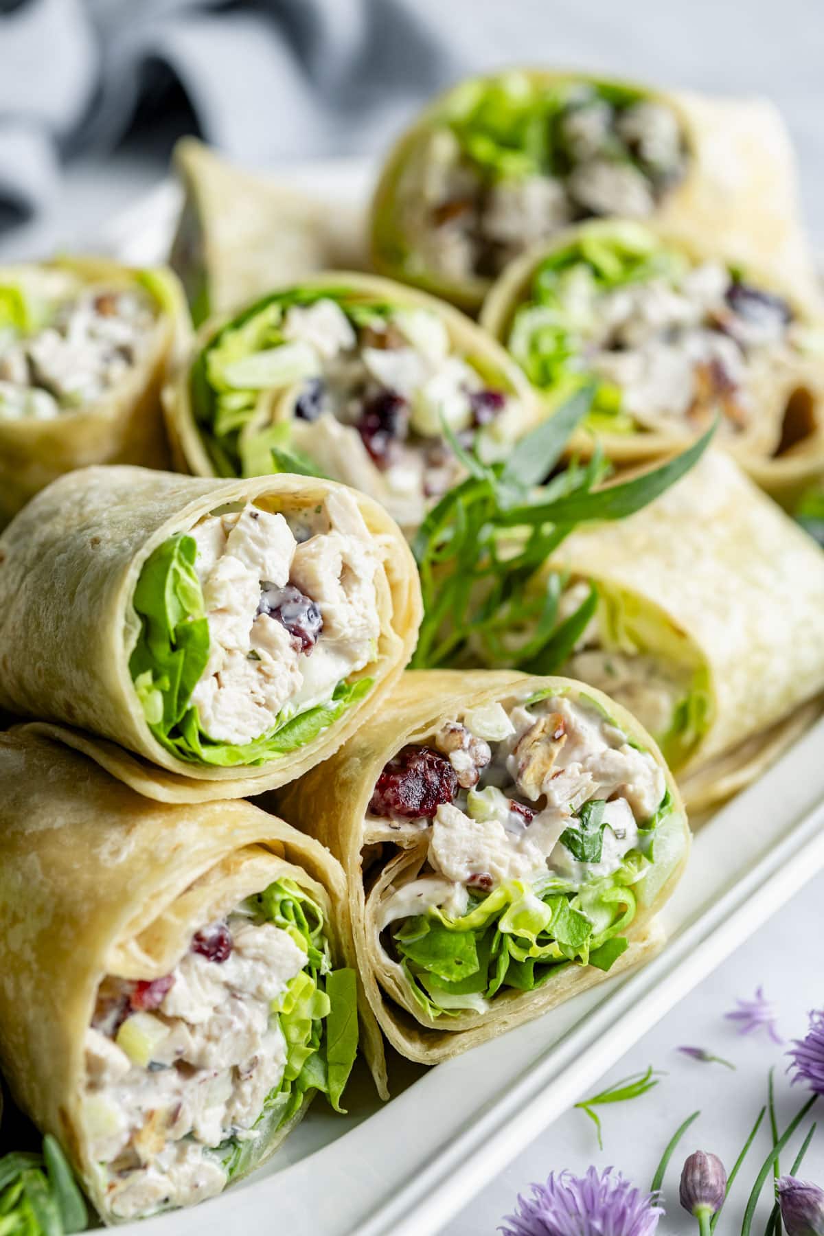 the chicken salad wraps piled on a platter