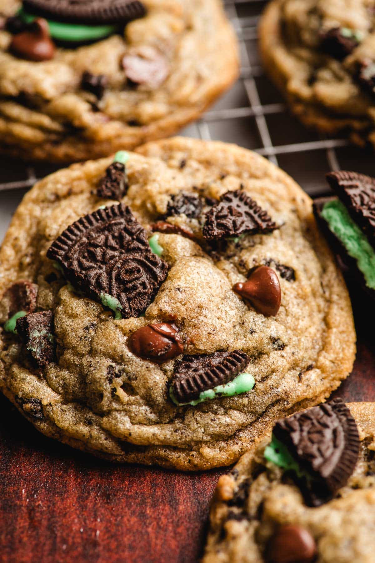 A Mint Oreo Chocolate Chip Cookie on a cooling rack.