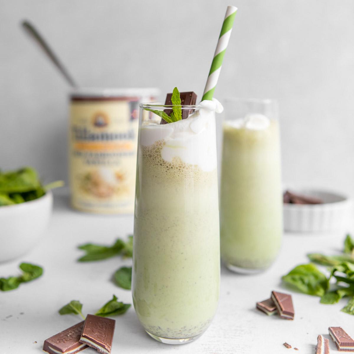 square photo of a shamrock shake with ingredients in background