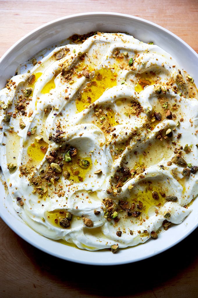 A platter of whipped ricotta with honey, olive oil, and pistachios.