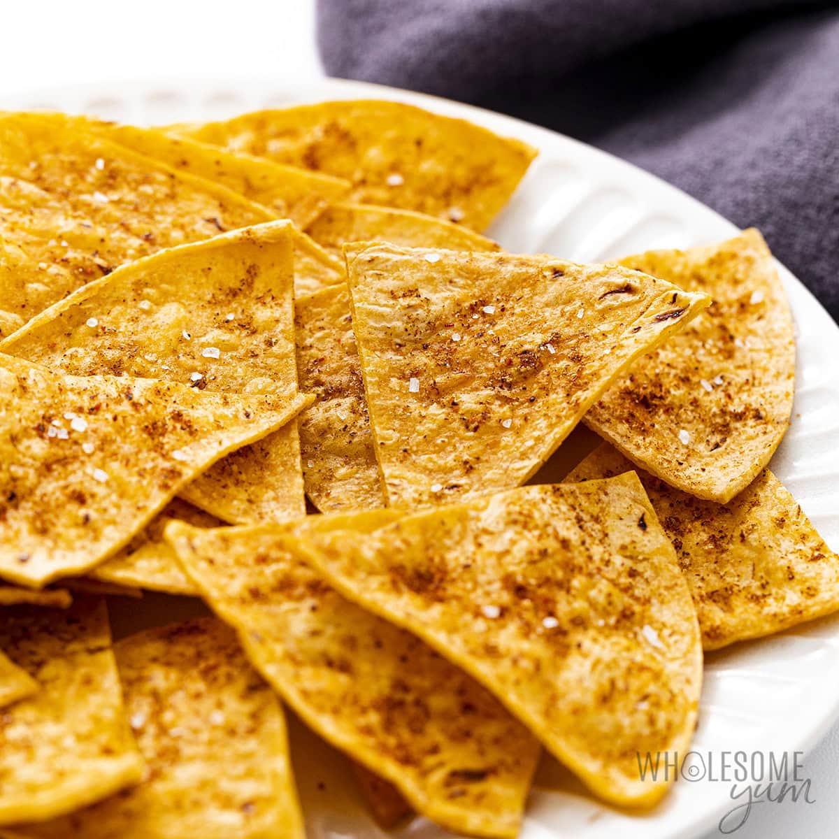 Homemade baked tortilla chips on a plate.