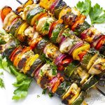 Chicken kabobs with vegetables and fresh herbs.